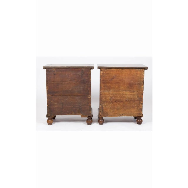 A handsome pair of mid-19th century South German walnut veneered comodini, executed in the Baroque taste with beautifully...