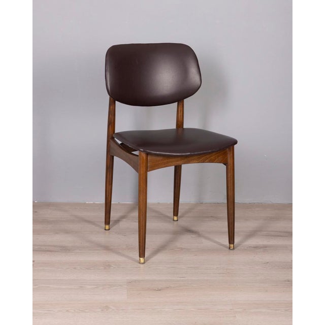 Set of eight chairs with wooden frame and gold-plated brass feet, upholstered in brown faux leather, designed by Anonima...