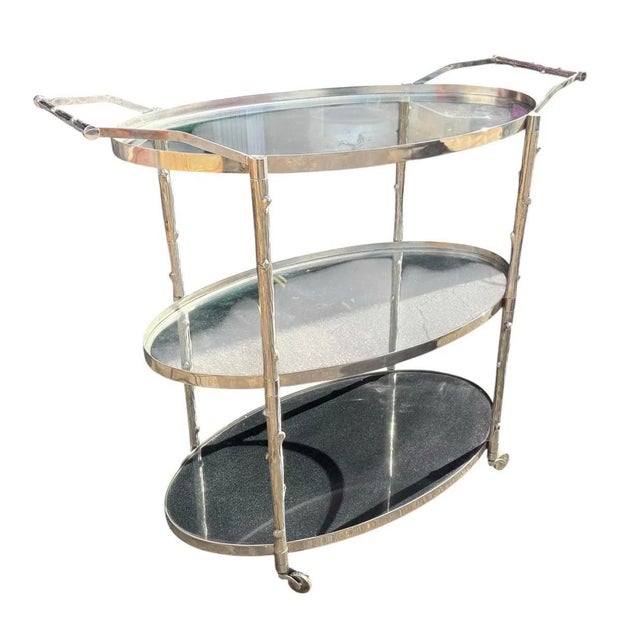 Modern Nickel Plated Faux Bois Bar Cart. Features 3 shelves with the bottom shelf having smoked glass.