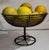 A antique wire compote filled with nine antique stone lemons or alabaster lemons . Lemons are roughly 2inches x 3 inches...