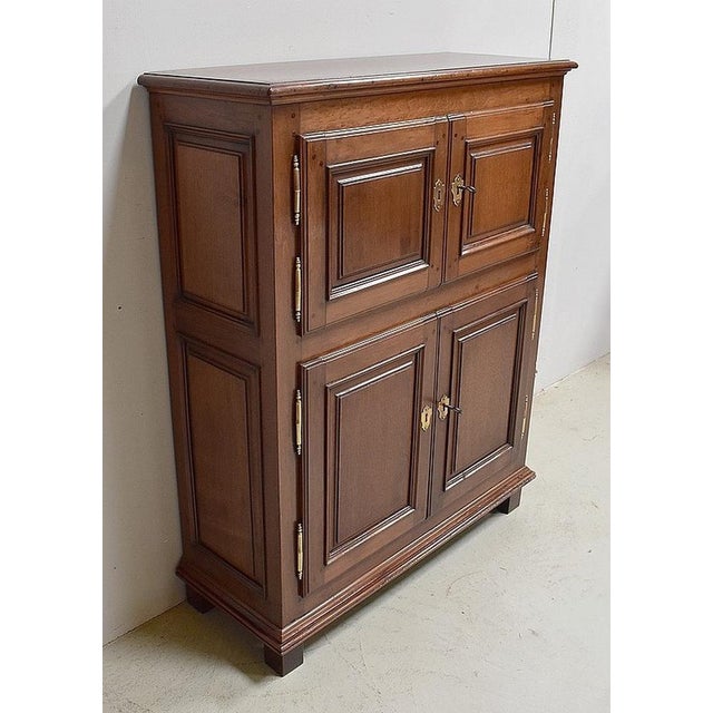 Small buffet with a solid walnut support opening by 4 doors, each decorated with protruding moldings forming framing on...