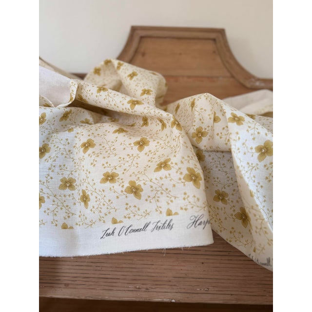 Leah O'Connell Textiles Harper in Ochre, 100% linen. Soft yellow floral on an off white ground. This fabric has been knit...