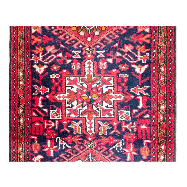 A beautiful early 20th century Persian Heriz runner with multiple stylized floral medallion running the length of the...