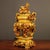 This is an ornate and substantial decorative censer (incense burner), crafted from cast bronze with a bright, golden...
