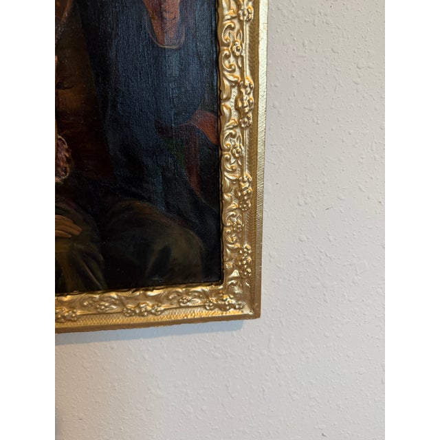 An evocative antique oil on canvas depicting an intimate interior genre scene of an elderly man seated with a young child...