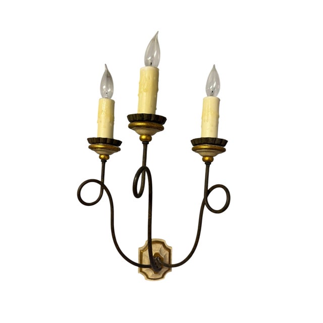 A pair of Italian parcel-gilt sconces from designers Dennis & Leen for luxury furniture manufacturer Formations....
