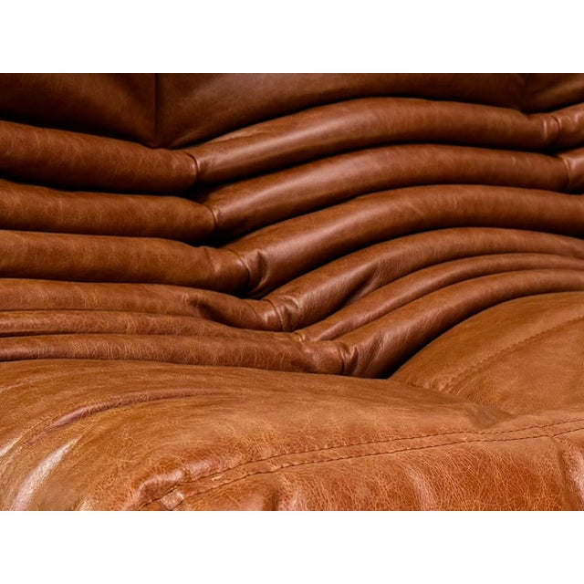 French Togo T3-Seater Sofa in Cognac Leather by Michel Ducaroy for Ligne Roset, in Restored conditions. Designed 1970 to...