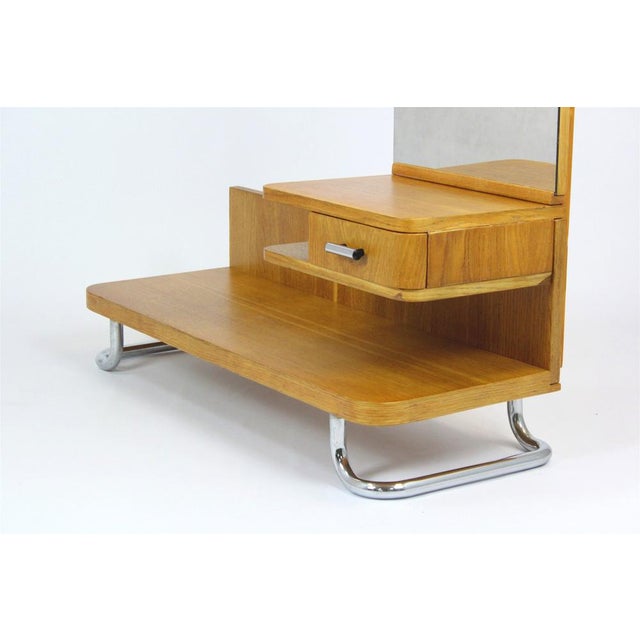 This Bauhaus style oak dressing table with mirror was produced in the 1940's in Czechoslovakia. The frame is made of...