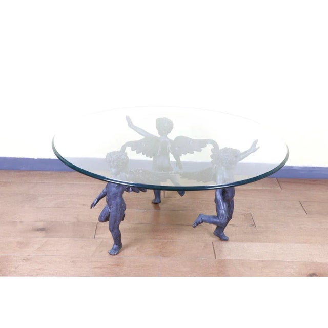 Great Bronze Dancing Cherubs Coffee Table with original patina. Very well made with many details. This beautiful bronze...