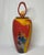 19” tall postmodern art glass jar vase with loop & ball finial lid. Predominantly red and taxi-cab yellow with multicolor...