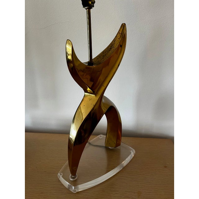 Gorgeous solid brass X shape sculptural modernist lamp with clear Lucite base. It is the style of Jean Arp, with a...