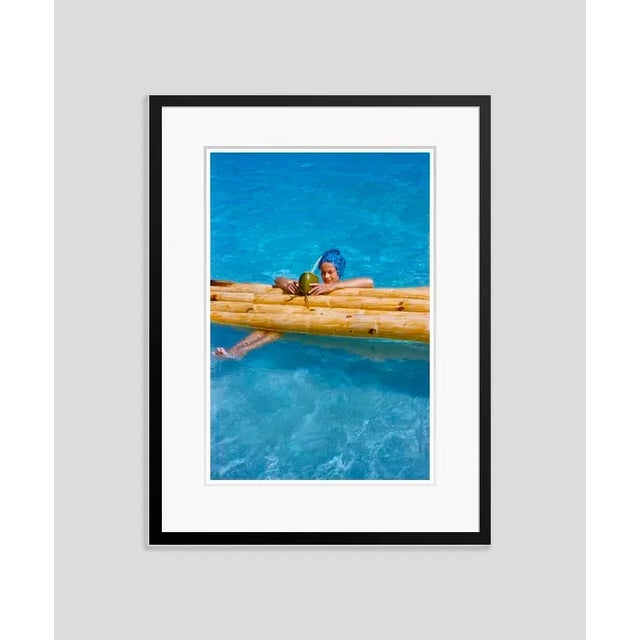 Drinks In The Pool At The Mill Reef 1959 by Toni Frissell A visitor enjoys a coconut milk drink in the swimming pool at...