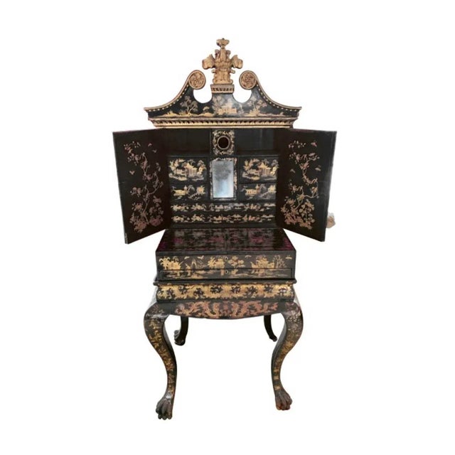 Black lacquer ladies writing desk featuring gold Chinoiserie scenes Two-cabinet door Handled removable chest Raised on...