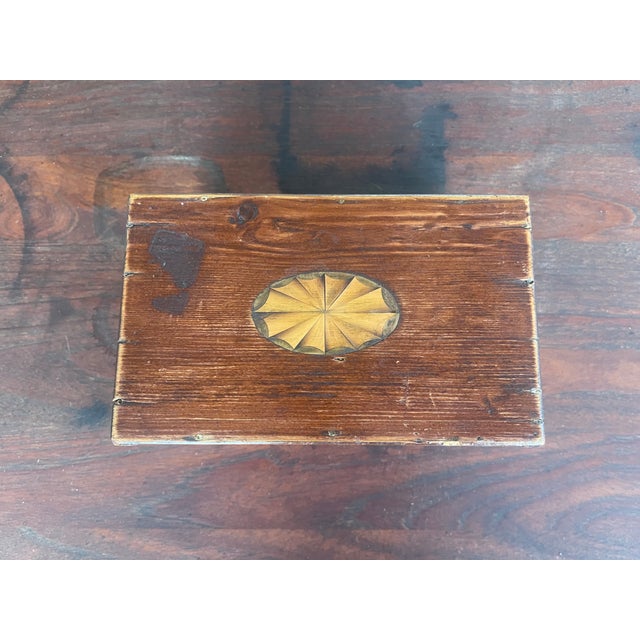 Here is an antique Georgian-style inlaid wooden tea caddy, likely dating from the late 18th century (circa 1790). Made of...