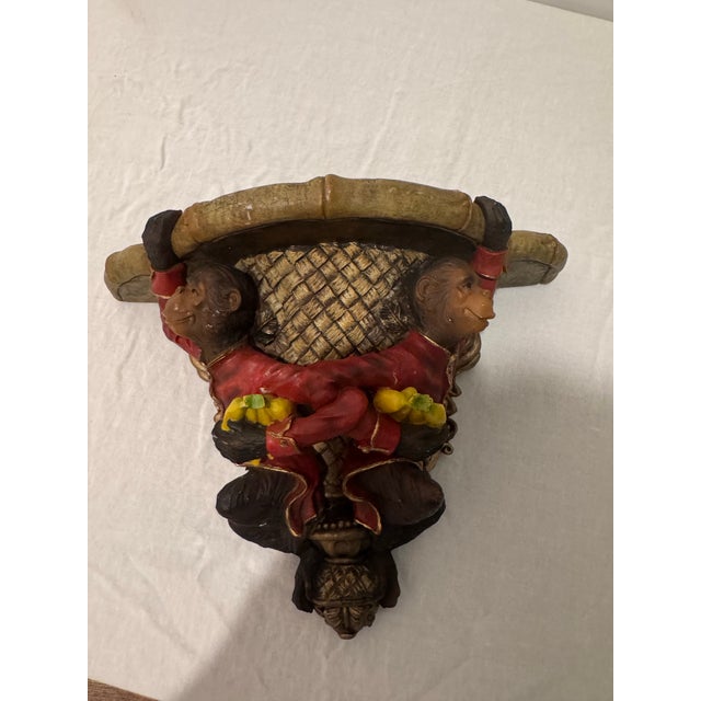 Add whimsy to your walls with this Hollywood Regency–style monkey wall shelf or sconce, featuring whimsical...