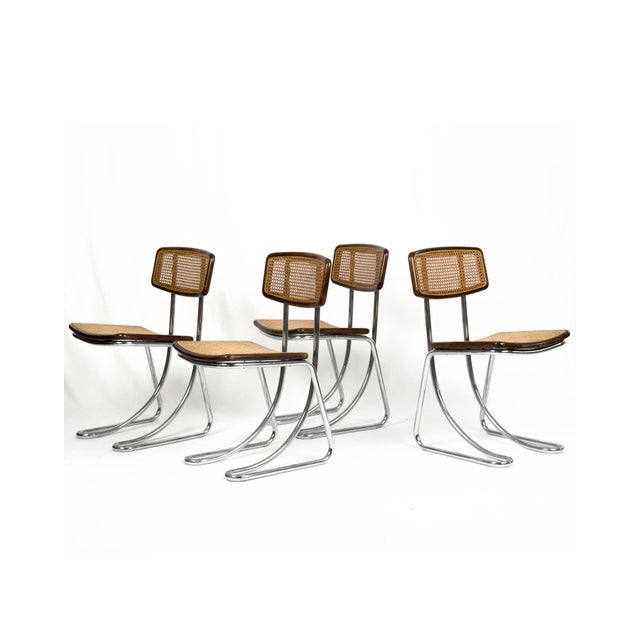 A striking set of 4 Italian cantilever dining chairs from the 1970s, combining chromed tubular steel with dark stained...
