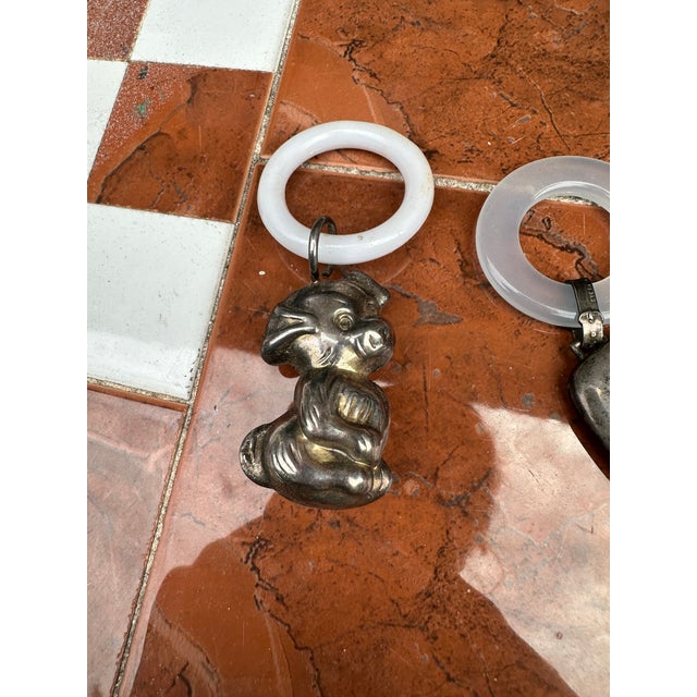 Up for consideration is a beautiful pair of silver metal baby toys. These would look lovely in your home and they are a...