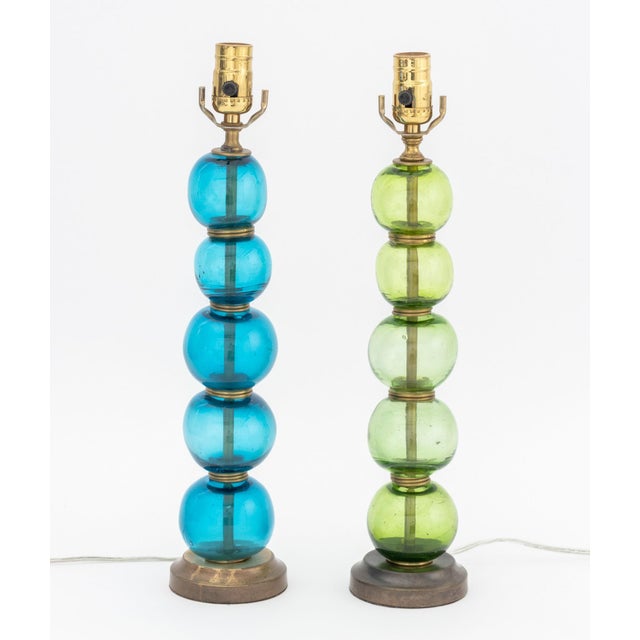 Pair of Mid-Century Modern Murano Glass Stacked Globes and Brass Lamps, one in green glass and one blue glass. Overall:...