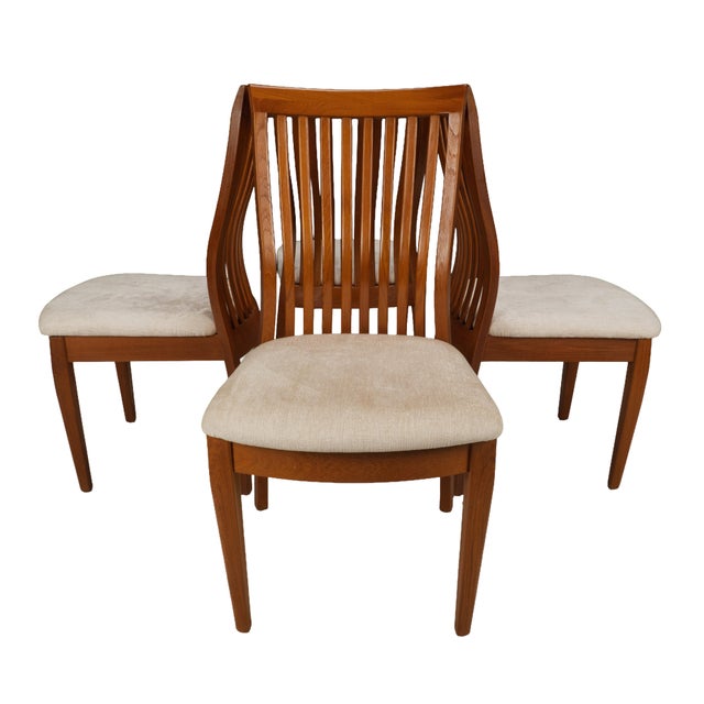 A well-balanced set of four teak dining chairs by Benny Linden Design, drawing from classic Danish modern lines. The...