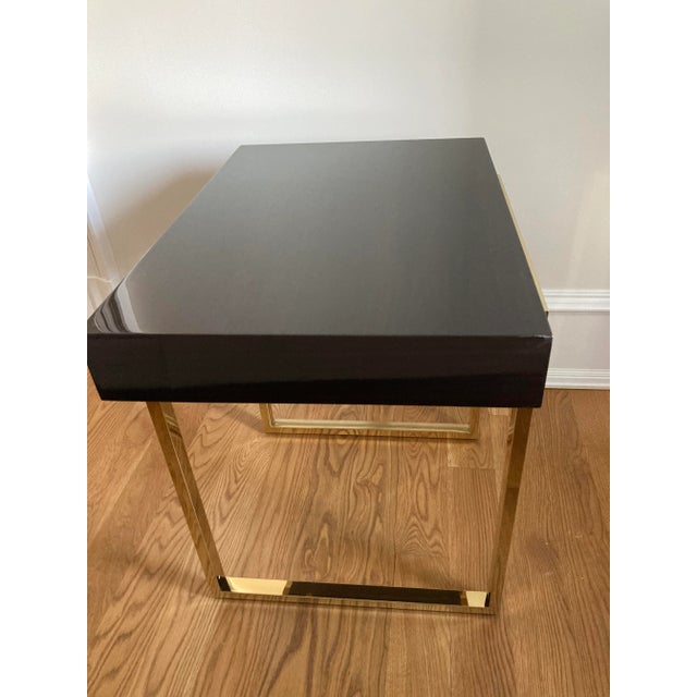 Pristine, polished, beautiful eucalyptus wood side table with modern polished brass base. Made by trade source Interlude...
