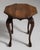 Carved octagonal side table in Rich Walnut Brown. Its rich walnut brown finish sets off scrolled cabriole legs, shaped...