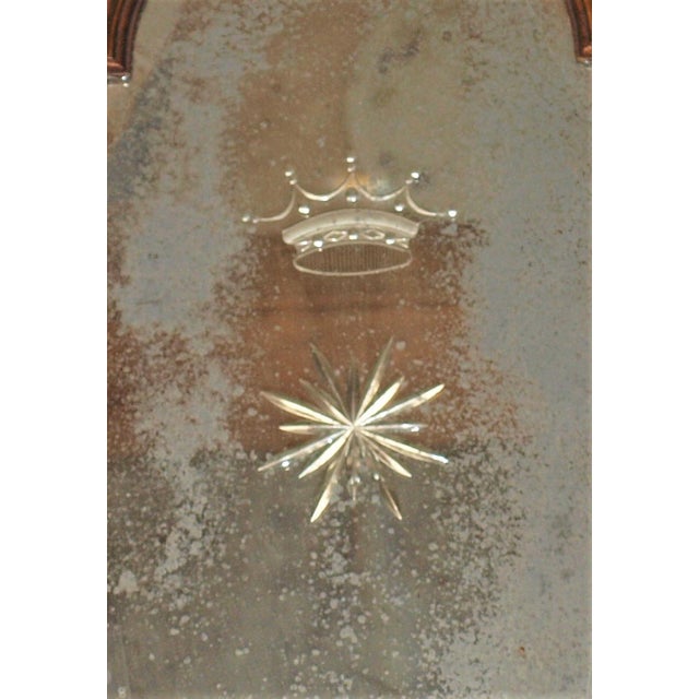 embellishment of a gold/silver gilt shell and leaves on top and a three-candle holder on bottom. Mirror is nicely aged...