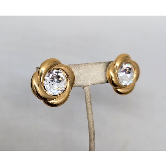Circa 1989 goldtone round clear Swarovski rhinestone pierced push back earrings. Marked "NAPIER©" on the backs. Measure: 1...
