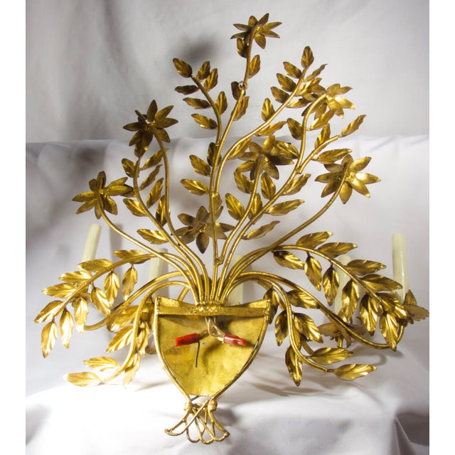 A unique gilt iron and tole five arm candle sconce in the form of a flower basket. This lighting fixture makes a dramatic...
