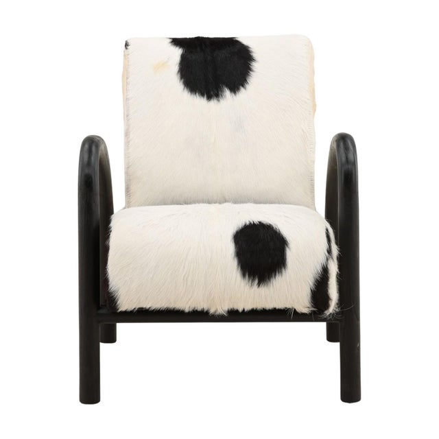 Handcrafted teak arm chair upholstered in genuine goat hide. A gracefully curved solid teak frame creates a bold...