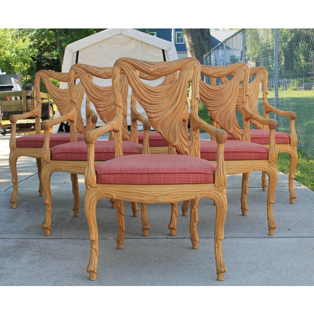 Set of six intricately carved armchairs in the style of Phyllis Morris, circa 1980s, marked Made in Italy. They feature...