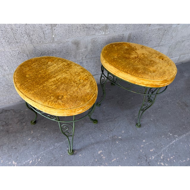 A pair of Vintage Mid-Century Modern Hollywood Regency Wrought Iron Bench / Foot Stools. Circa 1960s Features an avocado-...
