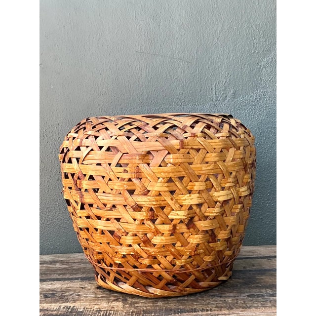This vintage Japanese ikebana basket brings sculptural presence and organic texture to a room. Handwoven from rattan, its...