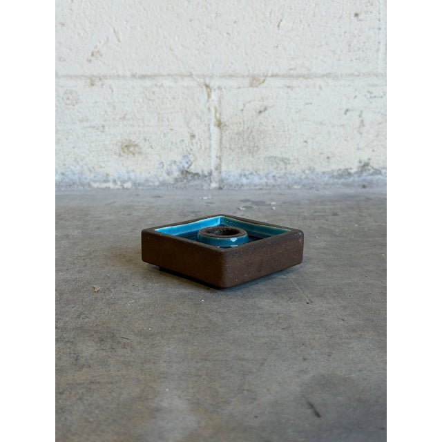 This minimalist Scandinavian studio ceramic candleholder features a crisp, geometric square silhouette balanced by rich...