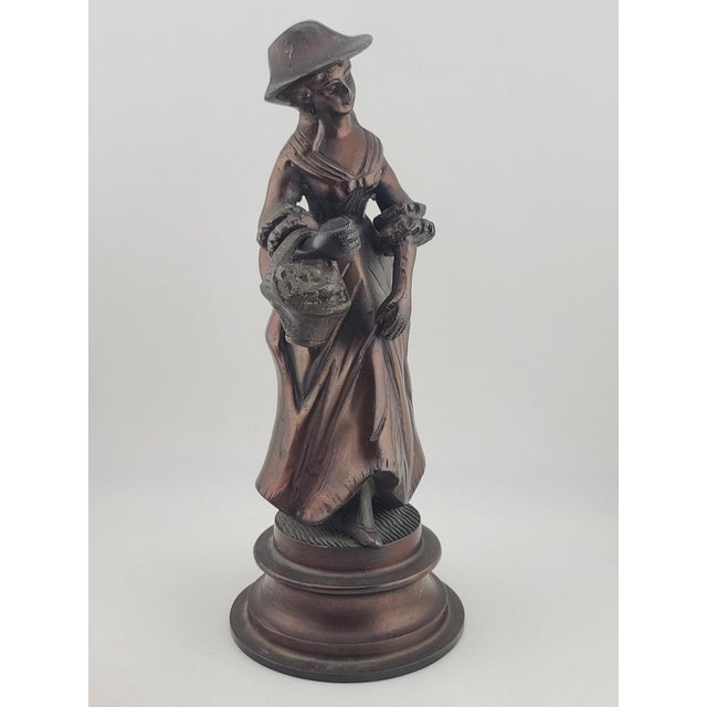 The Antique French Bronze Peasant Girl Figurine from c.1900 is an exquisite Art Nouveau statue measuring 8 inches in size....