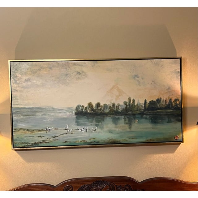 A beautiful oil painting floated in a gold guilded frame. Looks like a water, mountain and duck landscape. This is an oil...