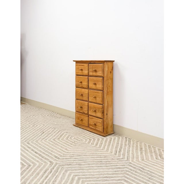 This charming small pine apothecary cabinet is a delightful and highly functional vintage find. Ten perfectly proportioned...
