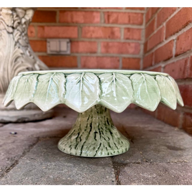 Vintage MCM Italian art pottery cake stand featuring green majolica turned-down leaf detail around the platter and a faux...