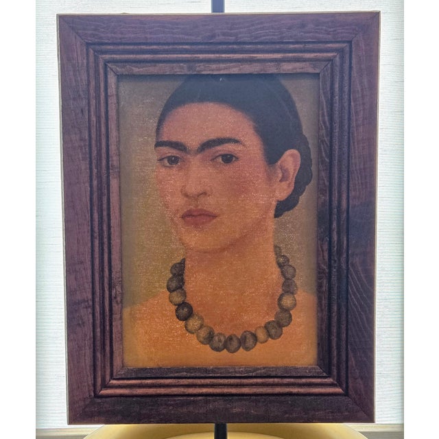 This vintage Turista Mexican folk art lithograph reproduction depicts Frida Kahlo’s iconic 1933 “Self-Portrait with...