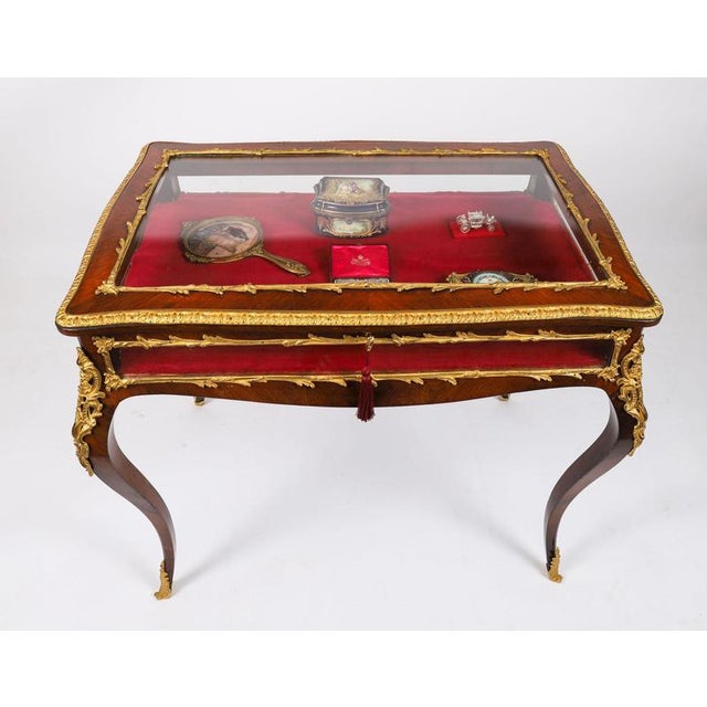 This is a beautiful antique French ormolu mounted Louis Revival bijouterie table, circa 1860 in date. The shaped top...