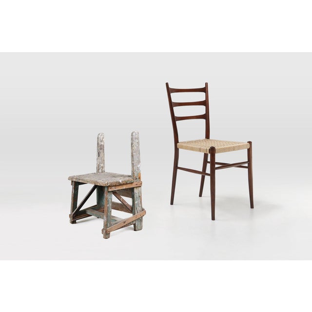 This early‑20th‑century French wooden stool embodies the quiet beauty of rural craftsmanship. Made around 1900, it carries...
