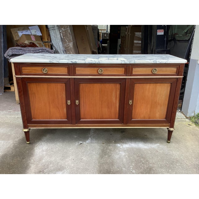Classic Louis XVI style credenza. Made of Mahogany, this stunning credenza features 3 doors and 3 drawers for ample...