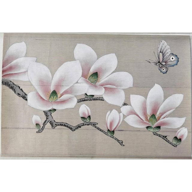 Luxury hand painted silk wallpaper sample featuring delicate magnolia blossoms, graceful branches, and a charming...