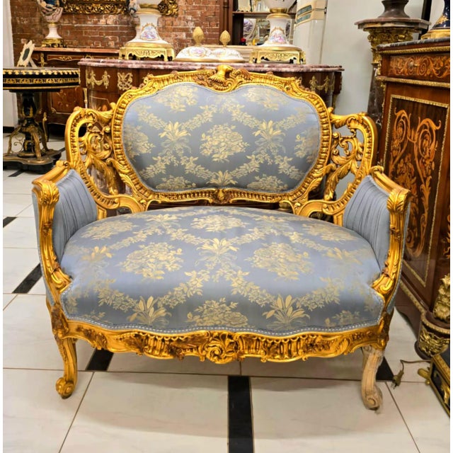Experience timeless elegance with this magnificent French Louis XV sofa, upholstered in luxurious blue damask fabric...