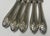 Set of five sterling handled knives with raised acanthus leaf decoration. Each handle marked, some partially rubbed. The...