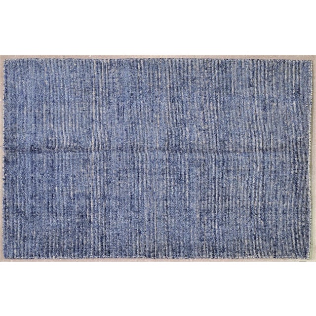 Hand-knotted with care using traditional rug making techniques, this wool rug blends timeless craftsmanship with a modern...