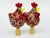Pair of lamp finials crafted from speckled glass chickens mounted on knurled brass finial bases sized to fit a standard-...