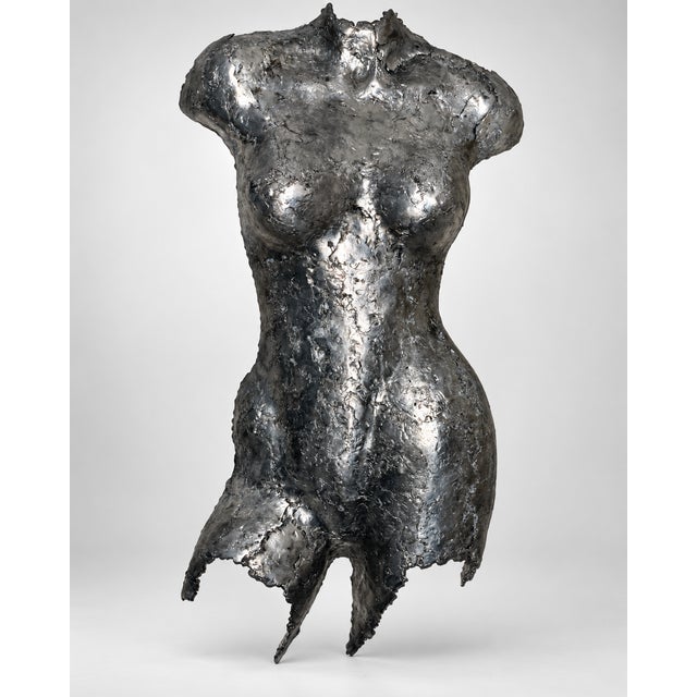 Striking sculptural female torso wall art by Rock Richardson, crafted in a pewter-toned silver finish with a highly...