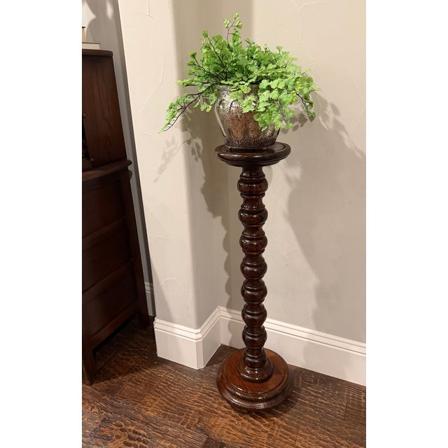 A wonderfully sculptural tall wood pedestal distinguished by an exceptionally bold continuous bobbin-turned central...