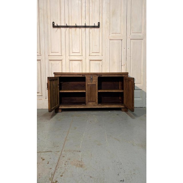 An 18th-century chestnut sideboard, crafted in Gothic style and featuring two finely decorated doors on the front. The...