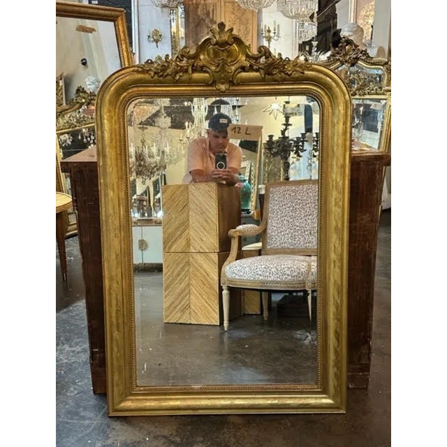 Exquisite 19th century French Louis Philippe giltwood mirror with a crest at the top. Adds a real touch of elegance!!